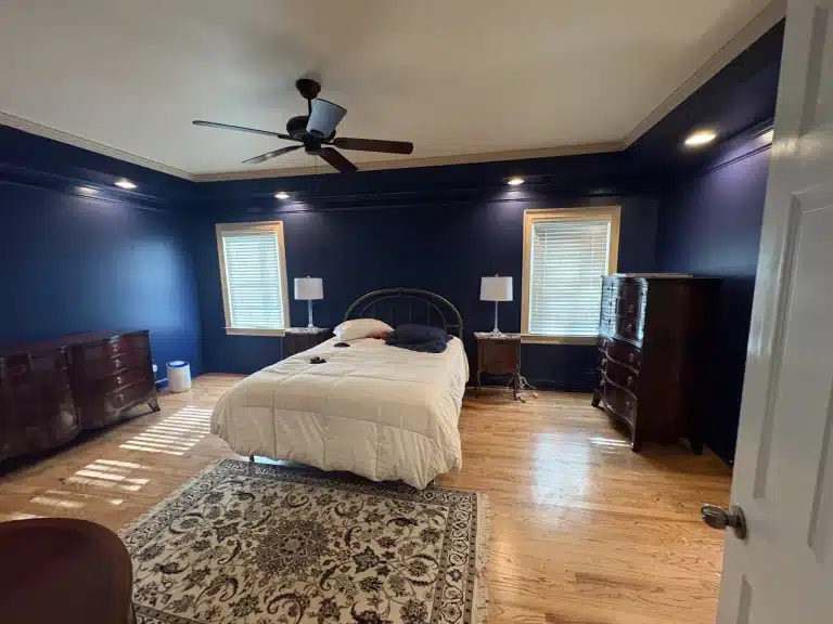 Bedroom painted deep navy blue with white trim — MG Barillas Painting