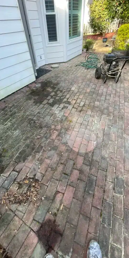 Before: Brick patio covered in grime and mildew before pressure washing