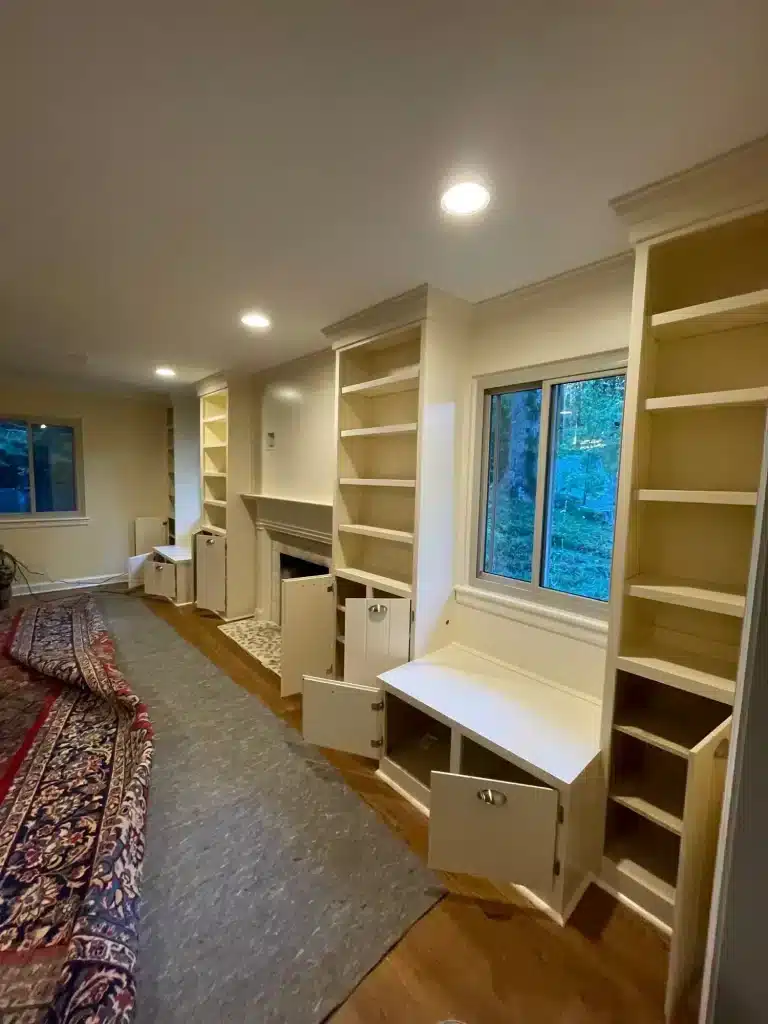 Built-in bookcases and cabinets around a fireplace painted cream — MG Barillas Painting