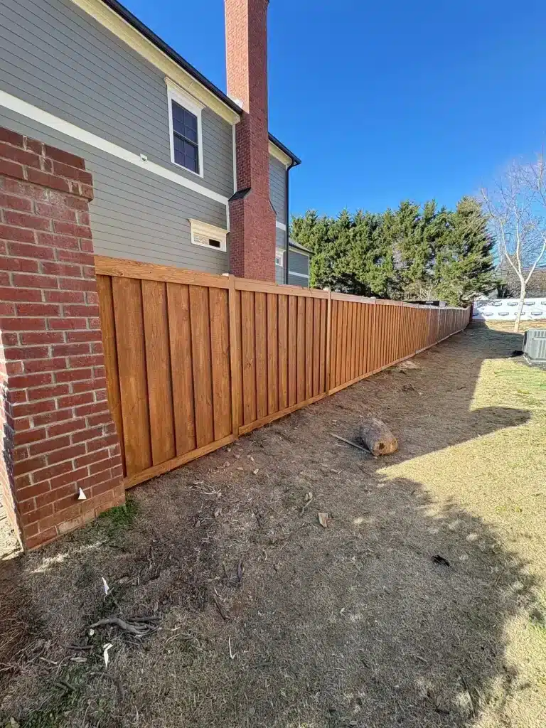 New cedar privacy fence stained a warm natural tone — MG Barillas Painting