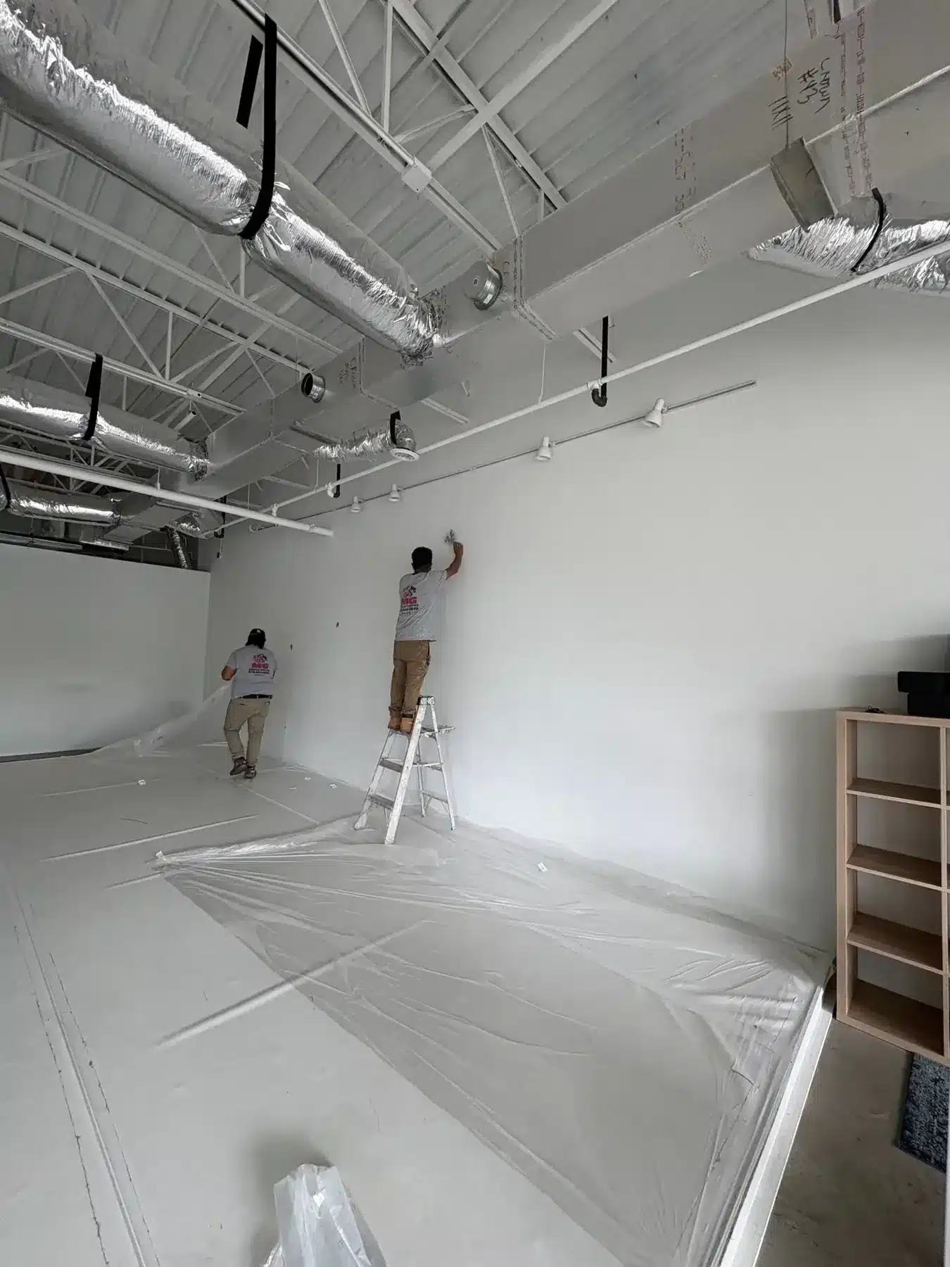 MG Barillas crew prepping walls in an open commercial space — MG Barillas Painting