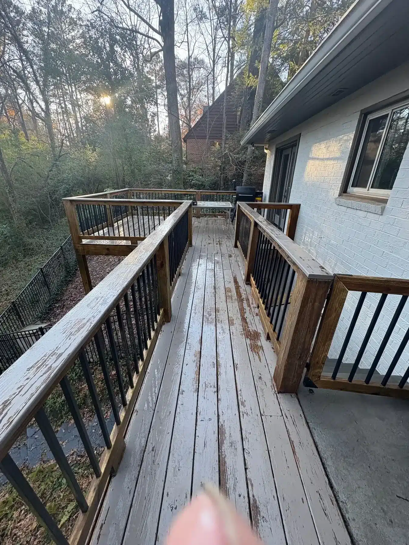 Before: Elevated deck with peeling, worn paint before restoration