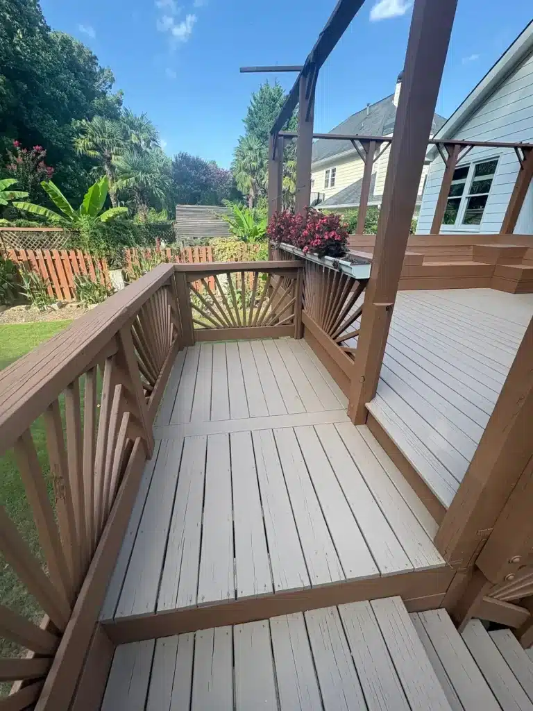 Two-tone deck with a sunburst railing and fresh stain — MG Barillas Painting