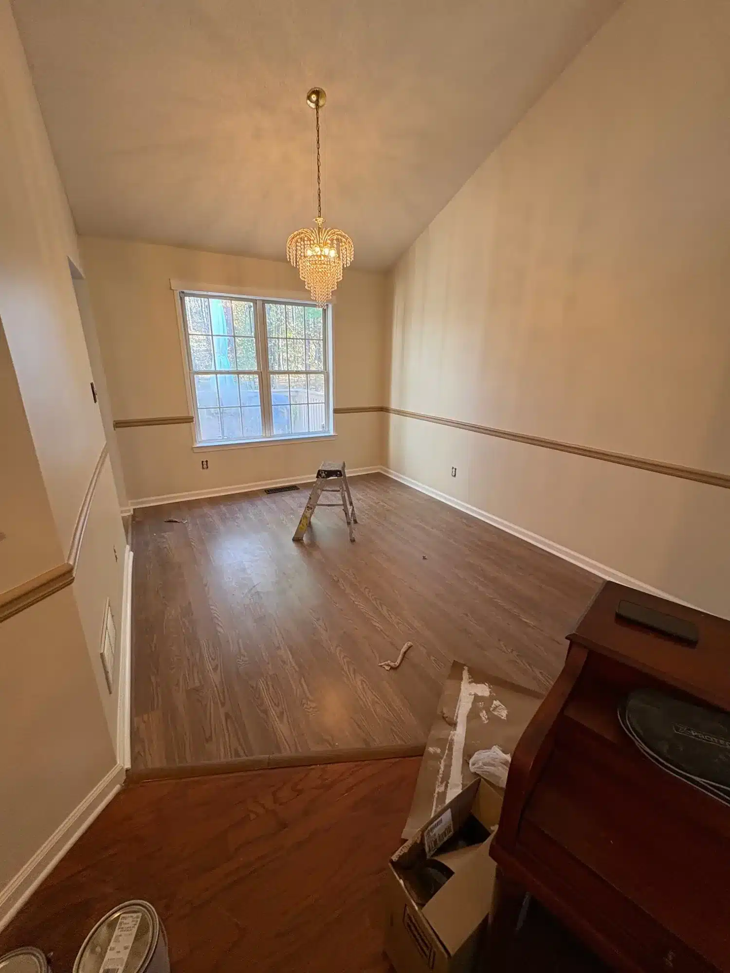 After: Dining room repainted a warm cream with a fresh chair rail