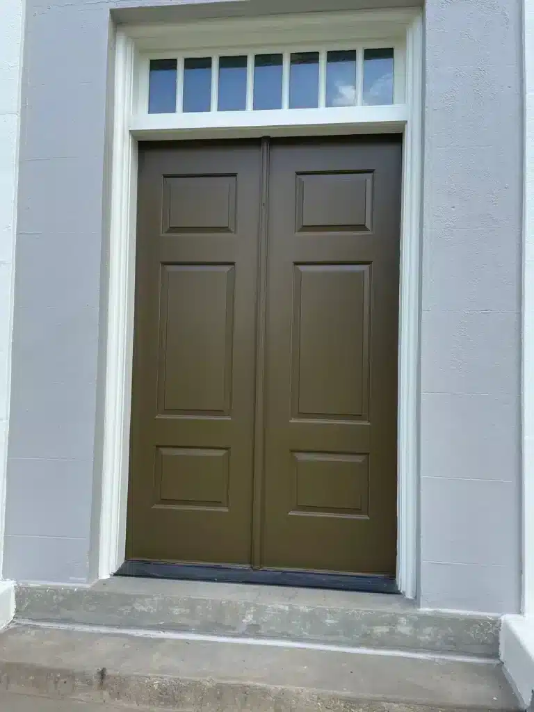 Double entry doors painted rich brown under a white transom — MG Barillas Painting