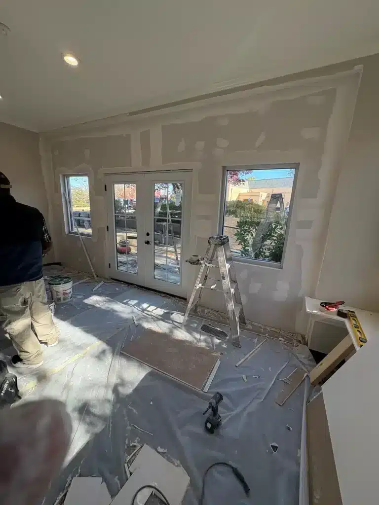 Family room drywall patched and primed with floors protected — MG Barillas Painting