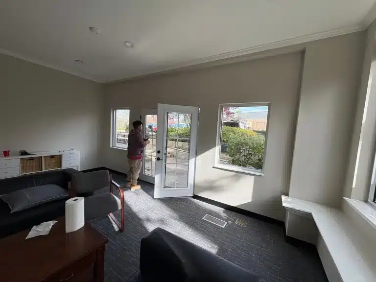Finished family room with smooth walls and fresh trim around French doors — MG Barillas Painting