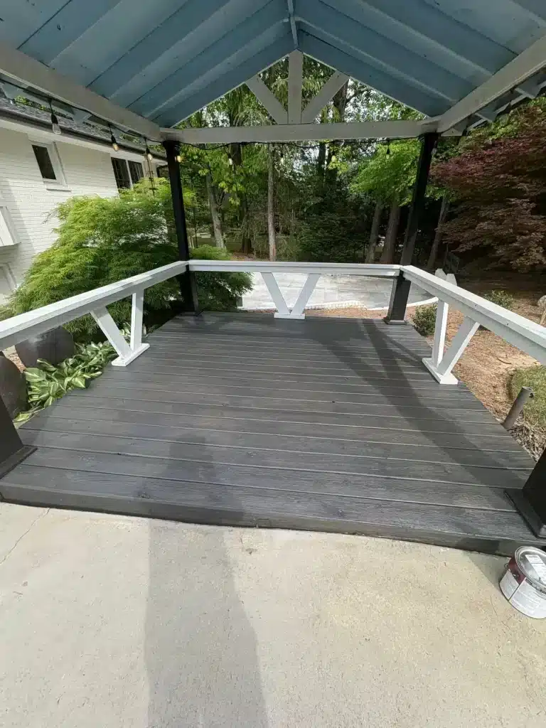 Covered gazebo deck stained charcoal with white rails — MG Barillas Painting
