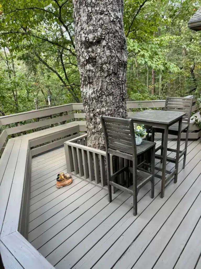 Gray painted deck with railing around a large tree — MG Barillas Painting