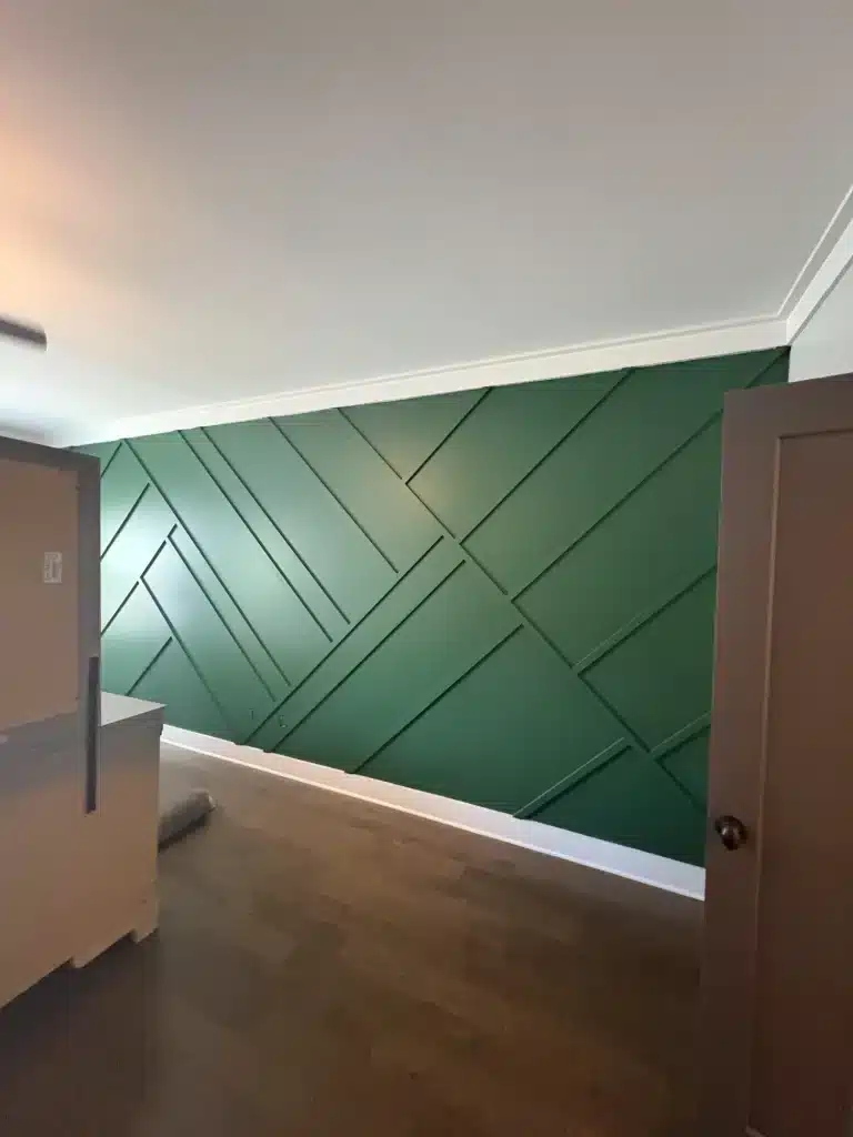 Green accent wall with geometric trim pattern — MG Barillas Painting