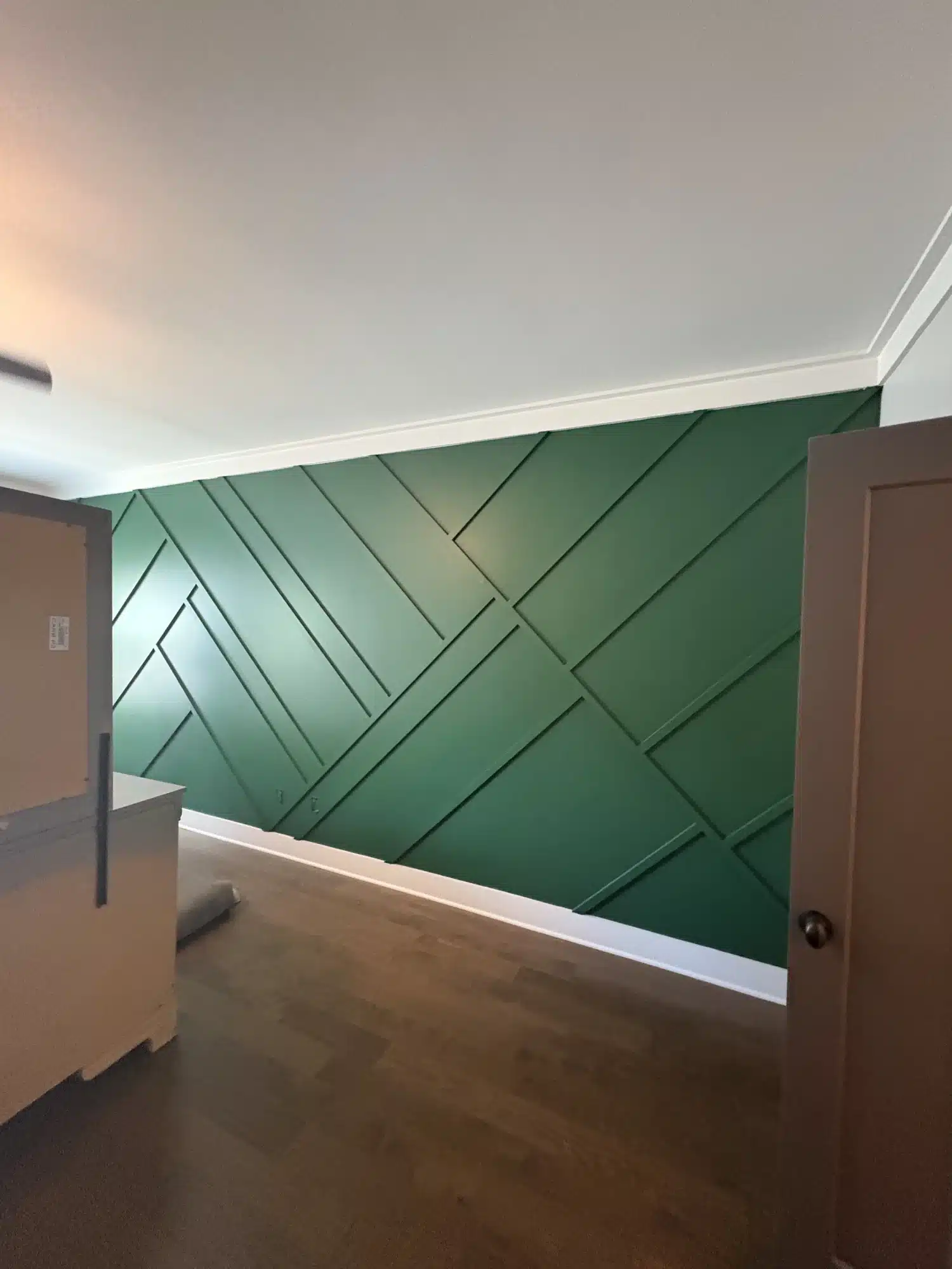 Green accent wall with geometric trim pattern — MG Barillas Painting