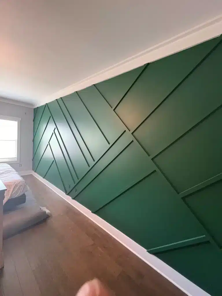 Bedroom accent wall with geometric trim painted deep green — MG Barillas Painting