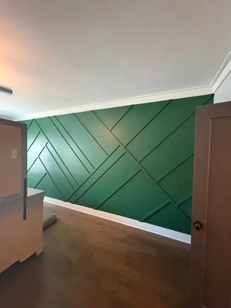 Geometric green accent wall with crisp white trim and ceiling — MG Barillas Painting