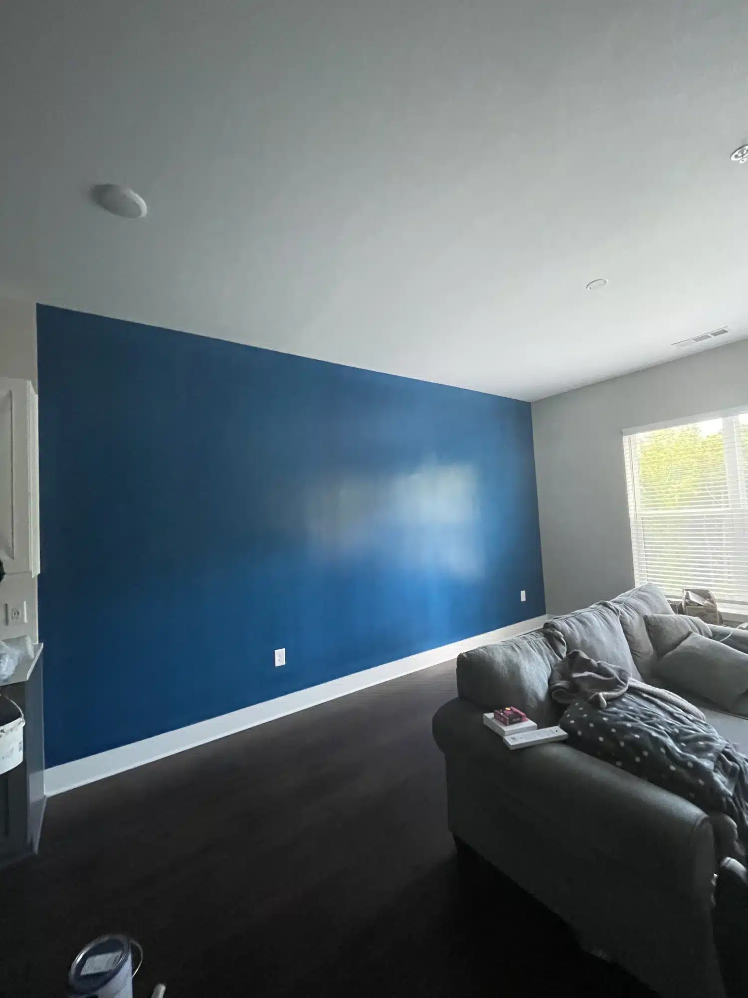 Living room with a deep blue accent wall — MG Barillas Painting