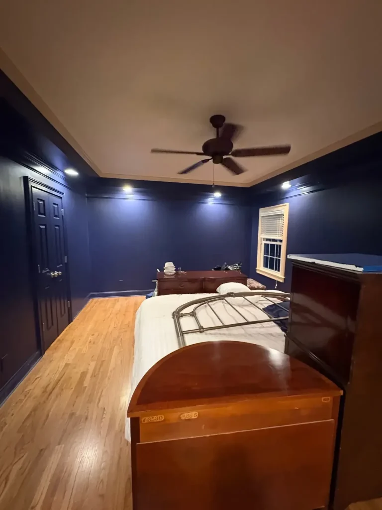 Navy bedroom walls and trim under recessed lighting — MG Barillas Painting