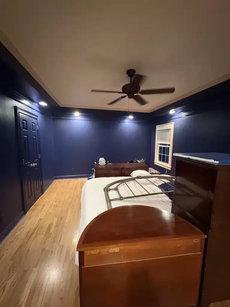 Navy bedroom with recessed lighting and painted ceiling — MG Barillas Painting