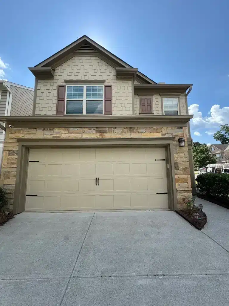 Finished exterior repaint on a two-story stone and siding home — MG Barillas Painting