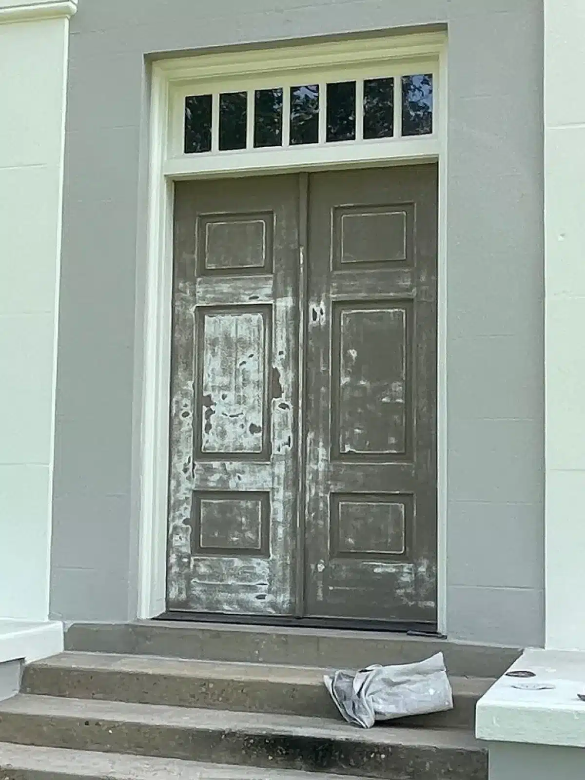 Before: Weathered double entry doors before refinishing